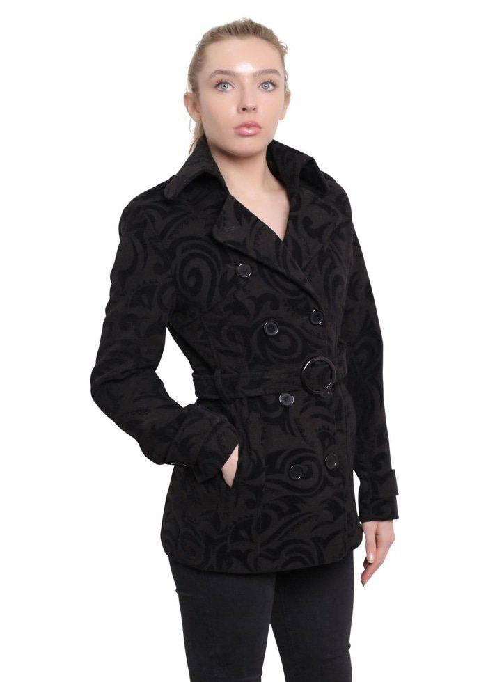 Woman wearing a black textured coat with a white background