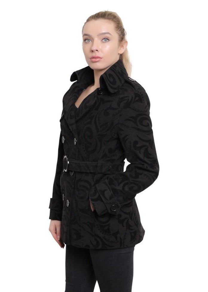 Woman wearing a black patterned coat on a white background