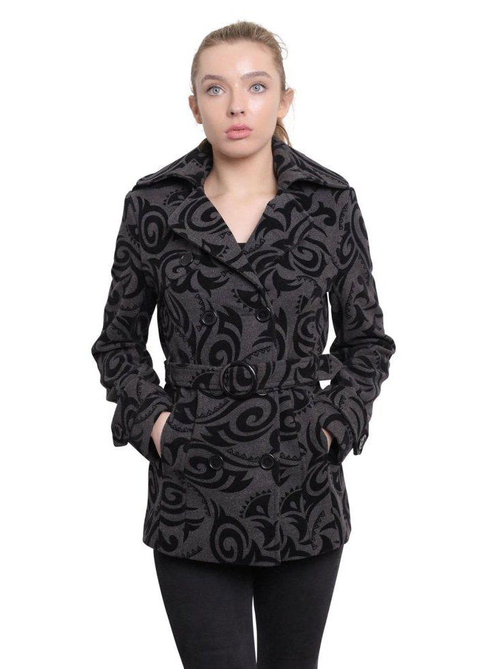Woman wearing a black patterned coat on a white background