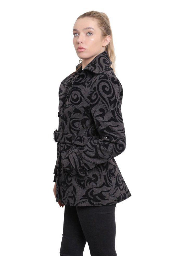 Woman wearing a black patterned coat on a white background