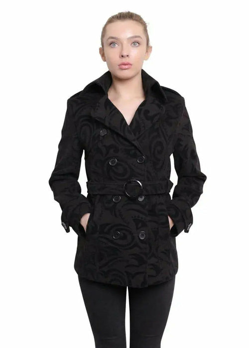 Woman wearing a black patterned coat on a white background
