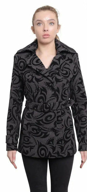 Woman wearing a black patterned coat with a white background