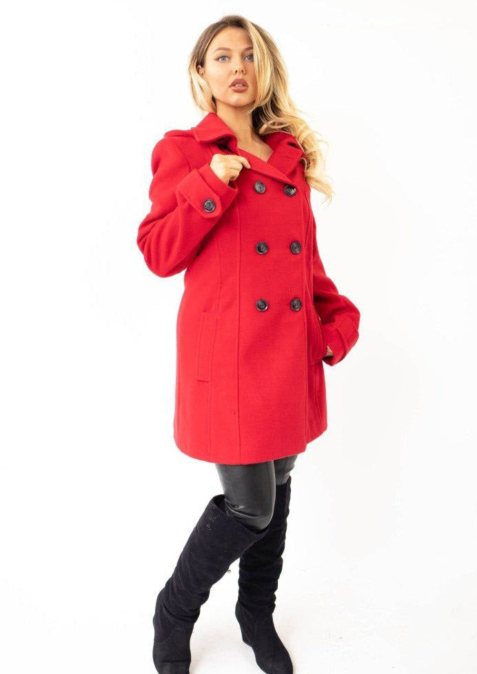 Woman wearing a red coat on a white background