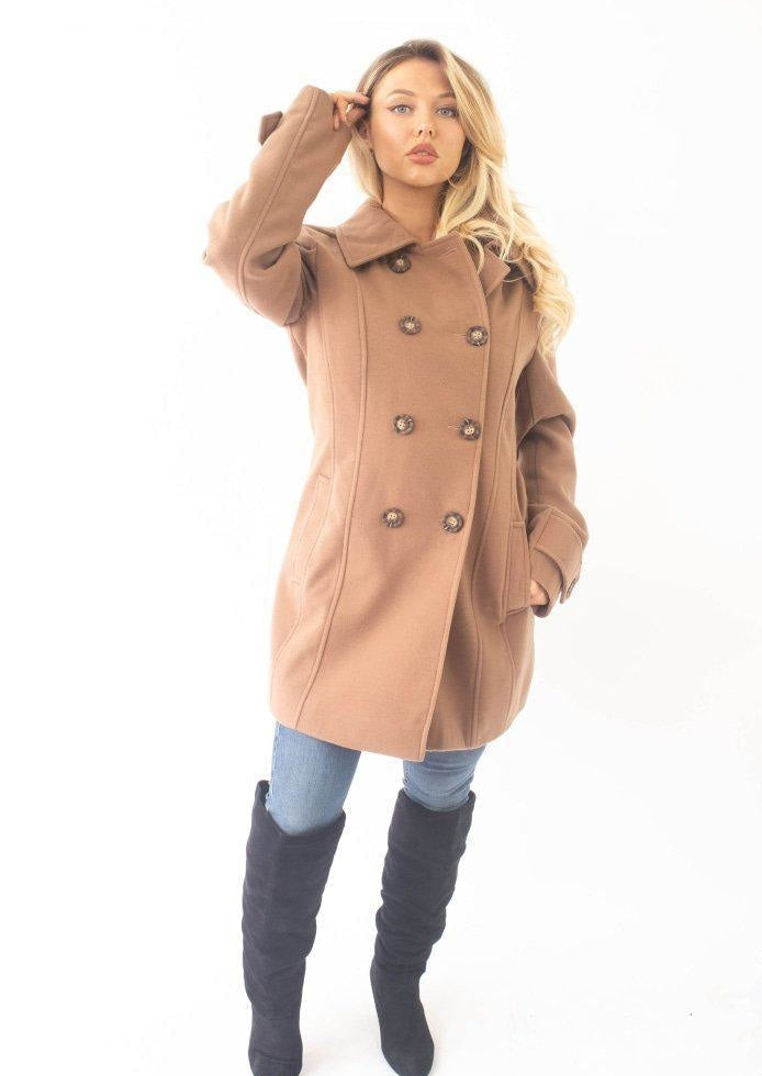 Woman wearing a brown coat with a white background