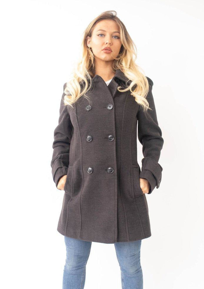 Woman wearing a dark gray coat with a white background