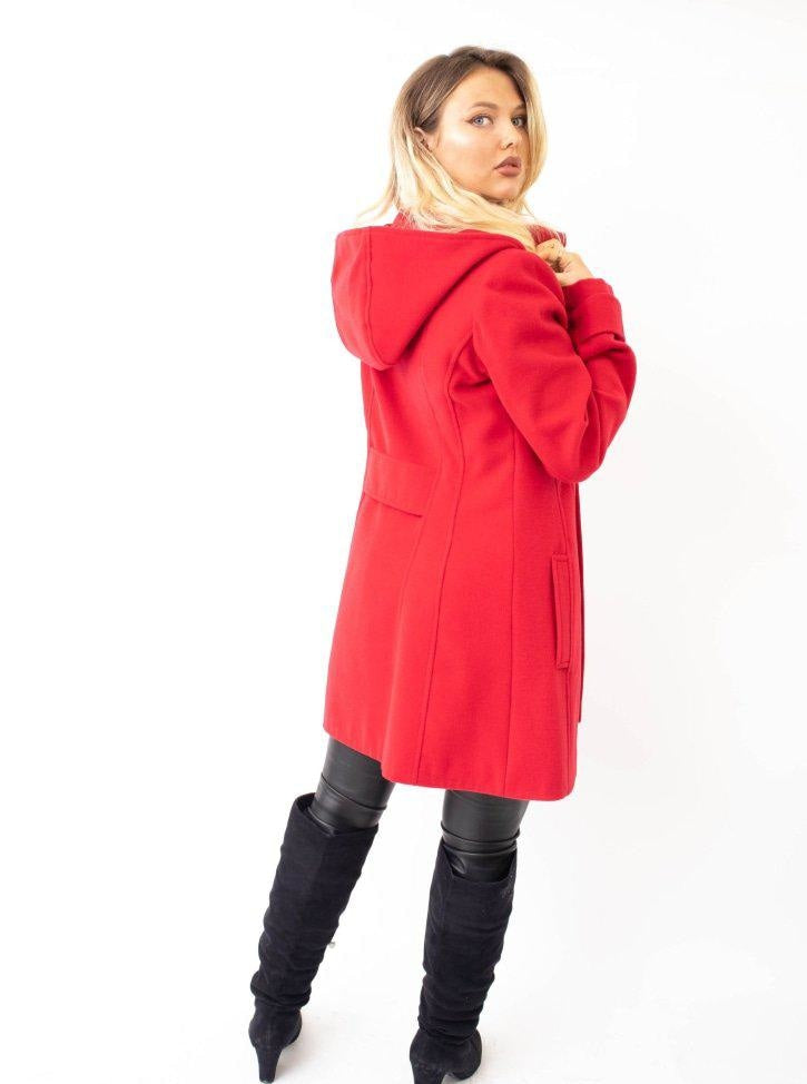 Woman wearing a red coat with a hood on a white background