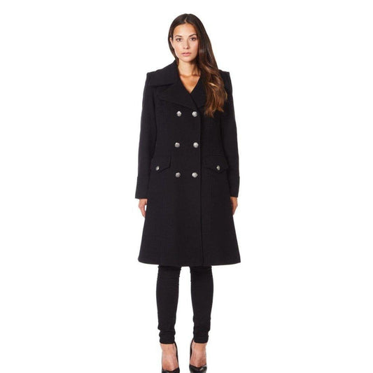 Woman wearing a black coat with silver buttons on a white background