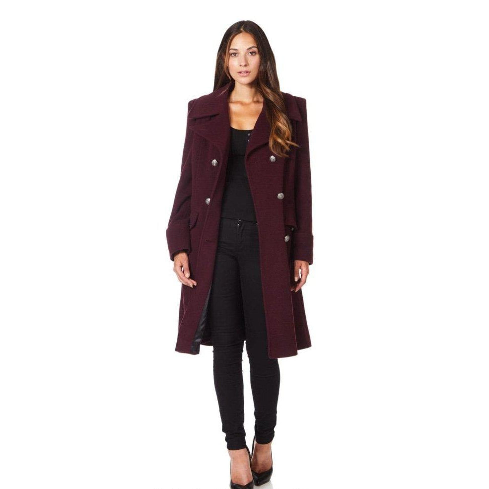 Woman wearing a burgundy coat on a white background