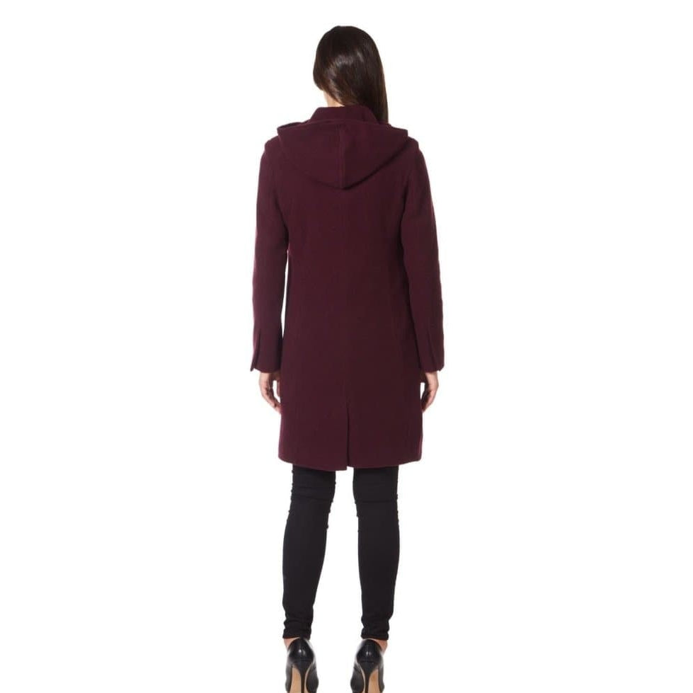 Person wearing a burgundy coat on a white background