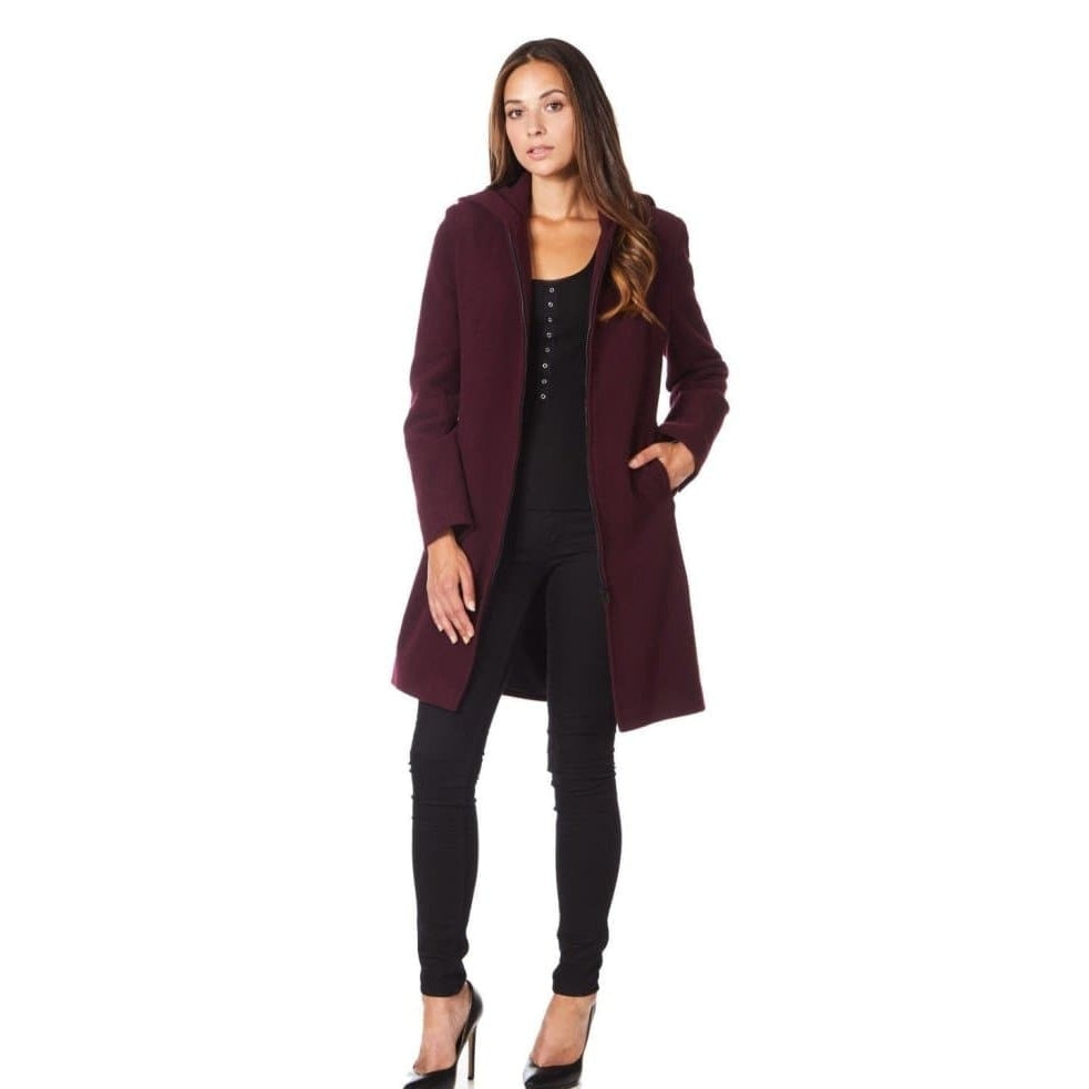 Woman wearing a burgundy coat on a white background