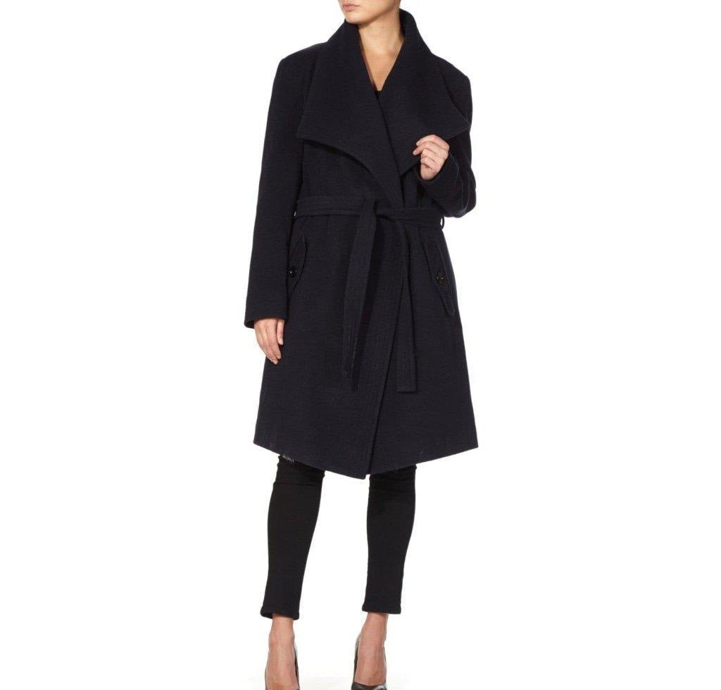 Black coat worn by a person on a white background