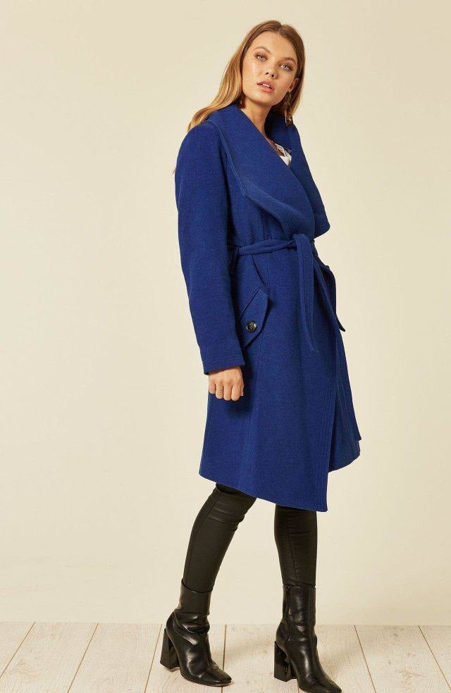 Woman wearing a blue coat with a white background