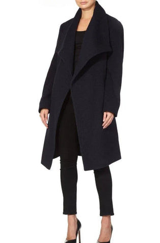 Black coat worn by a model on a white background.