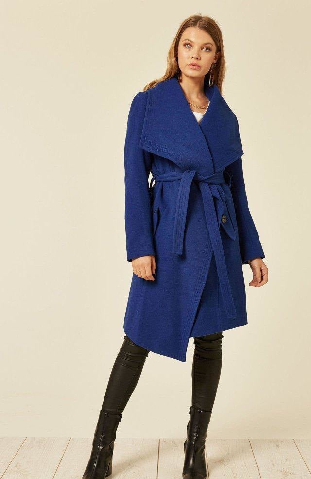 Woman wearing a blue coat with a white background