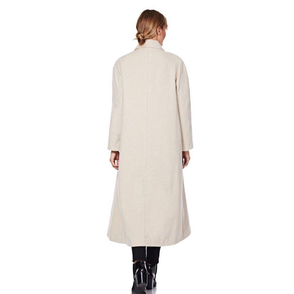 Woman wearing a long beige coat on a white background