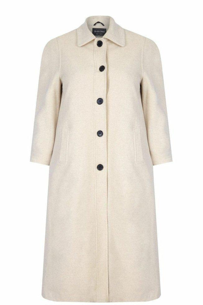 Beige coat with black buttons on a white background