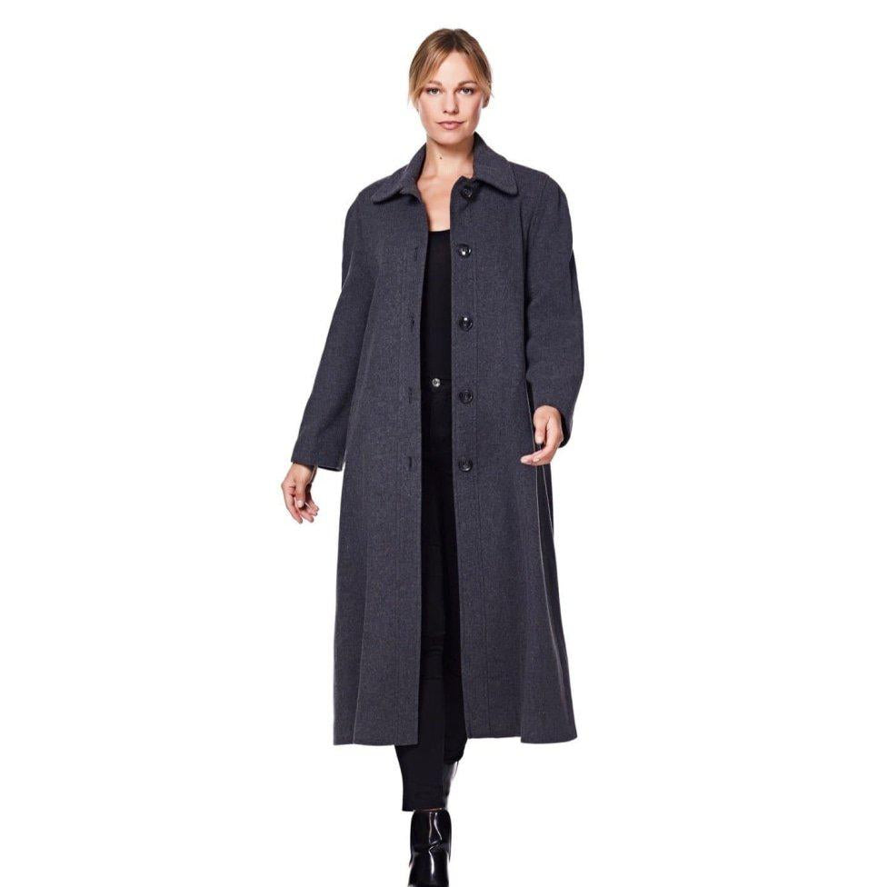Woman wearing a long dark coat on a white background