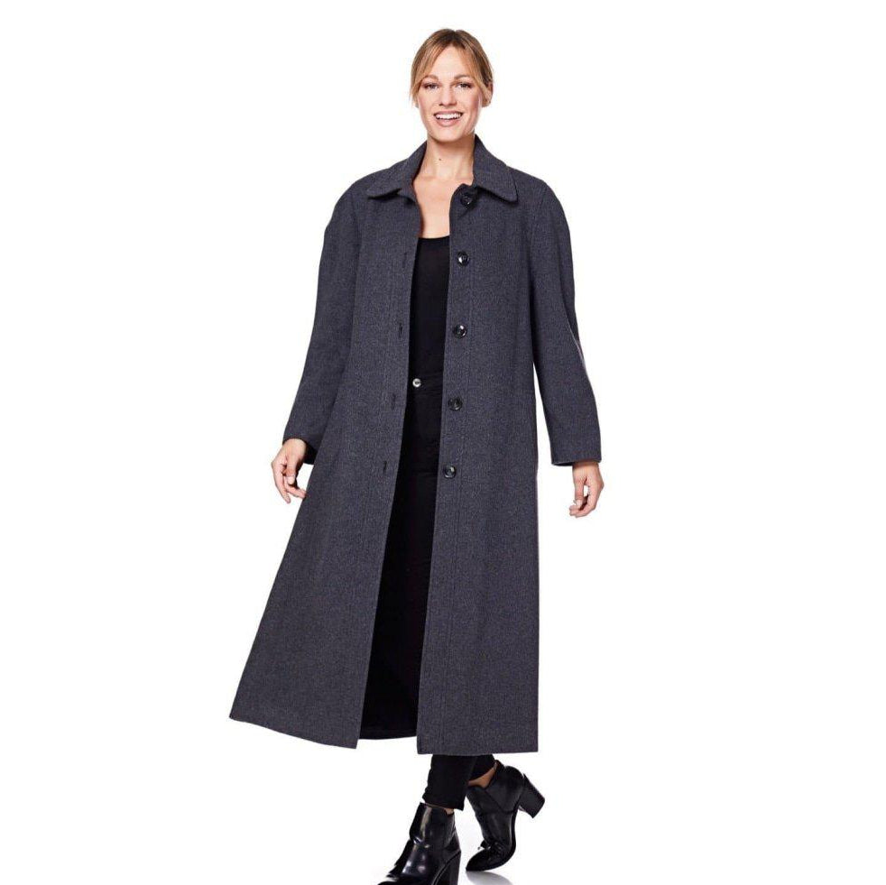 Woman wearing a long dark coat on a white background