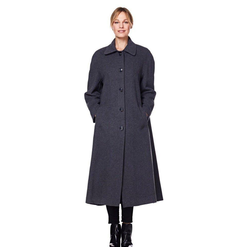 Woman wearing a long dark gray coat on a white background