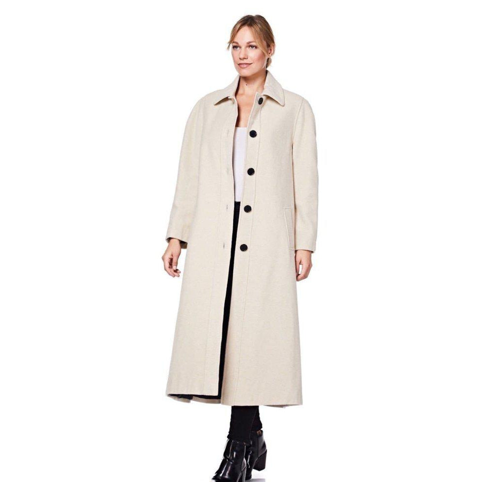 Woman wearing a long beige coat on a white background
