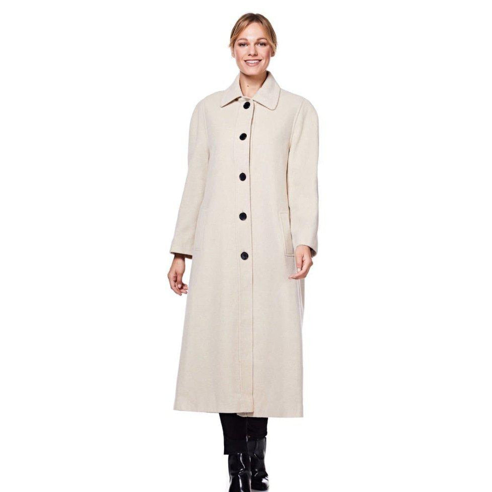 Woman wearing a beige coat with black buttons on a white background