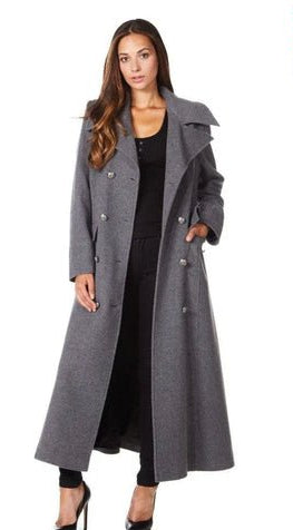 Woman wearing a long gray coat on a white background