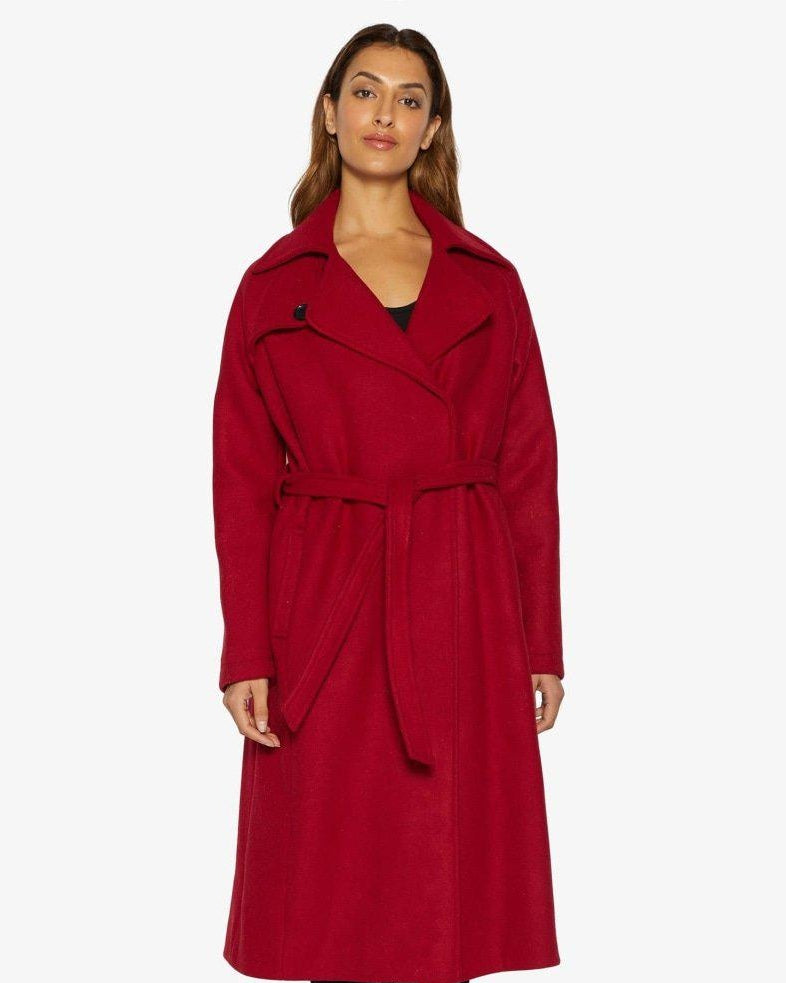 Woman wearing a red coat on a white background