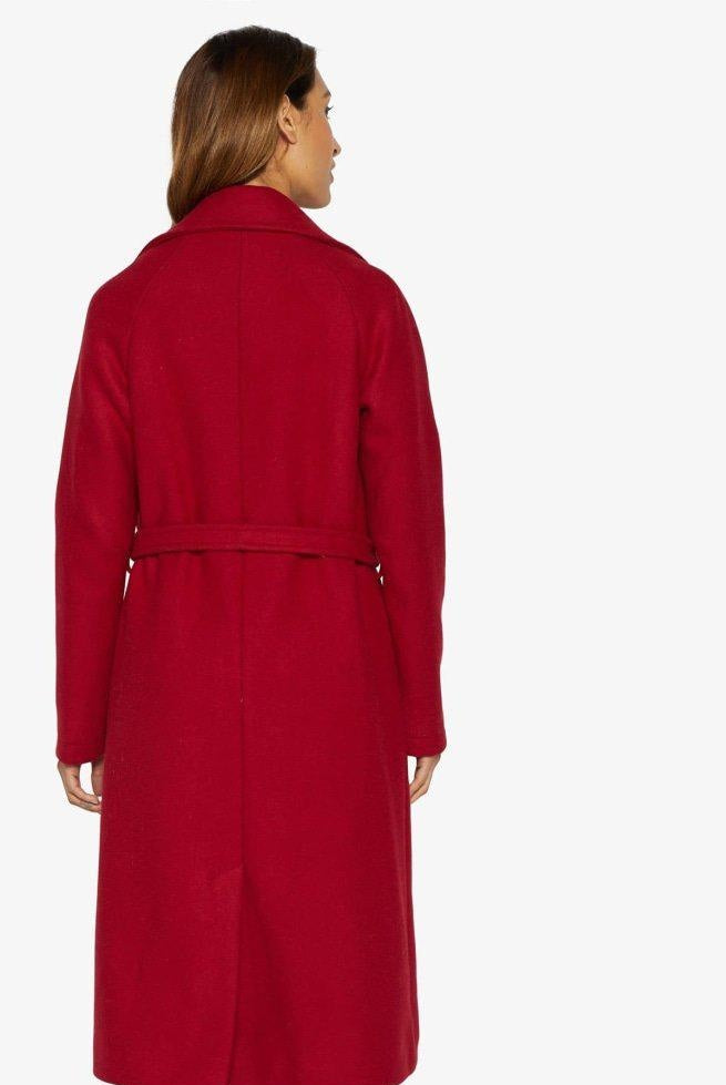 Red coat worn by a person on a white background