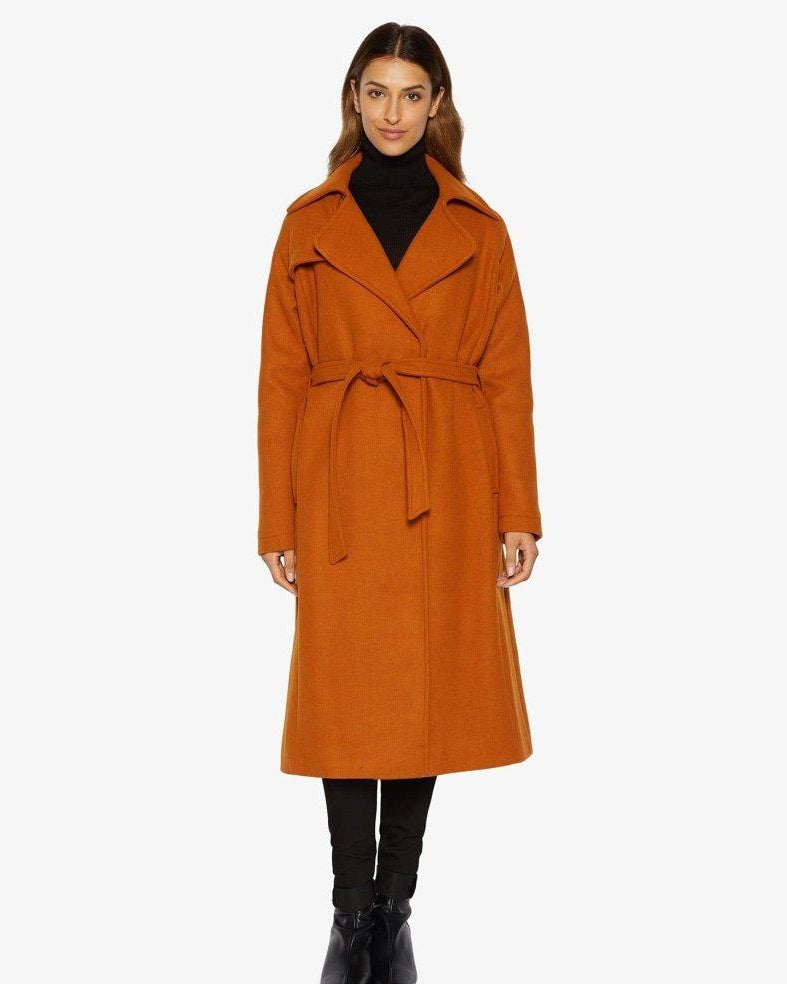 Woman wearing an orange coat on a white background