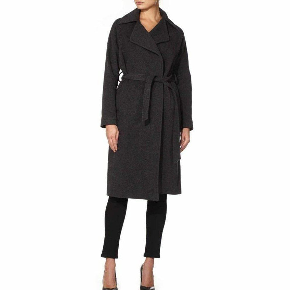 Woman wearing a black coat on a white background