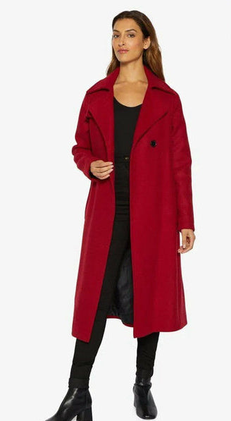 Woman wearing a red coat on a white background