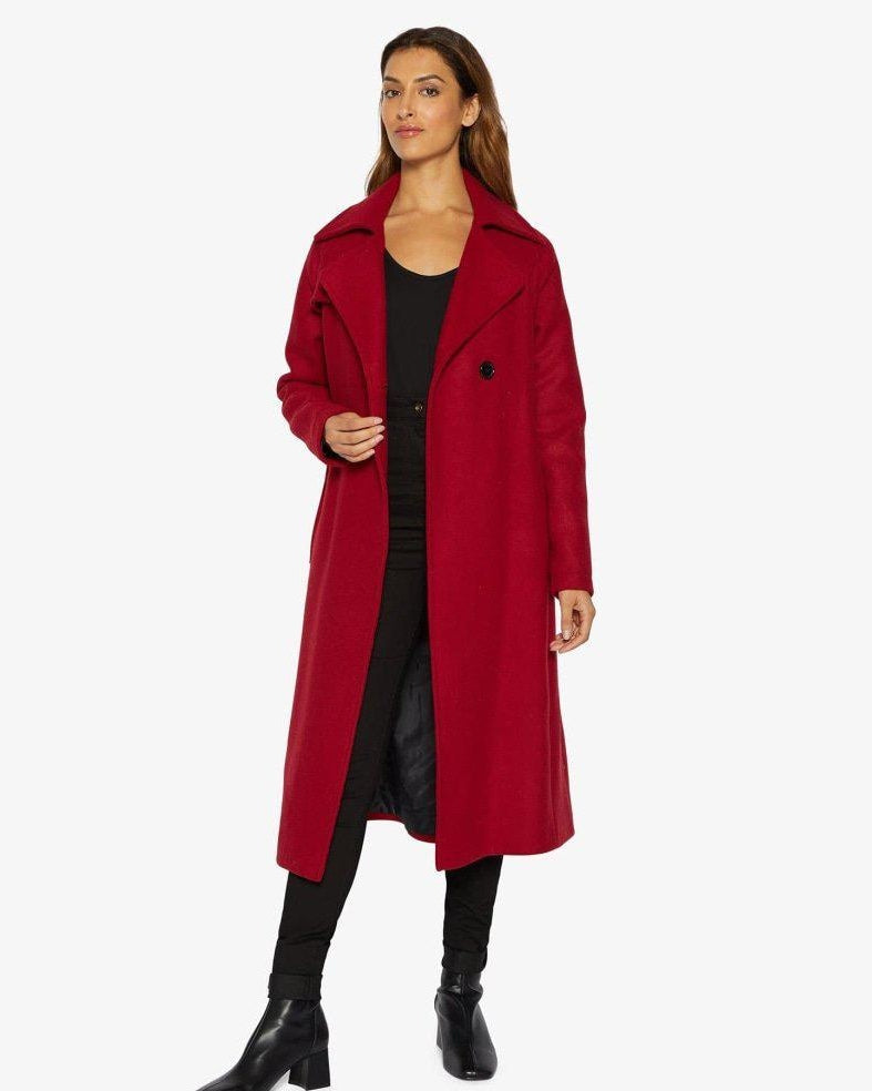 Woman wearing a red coat on a white background