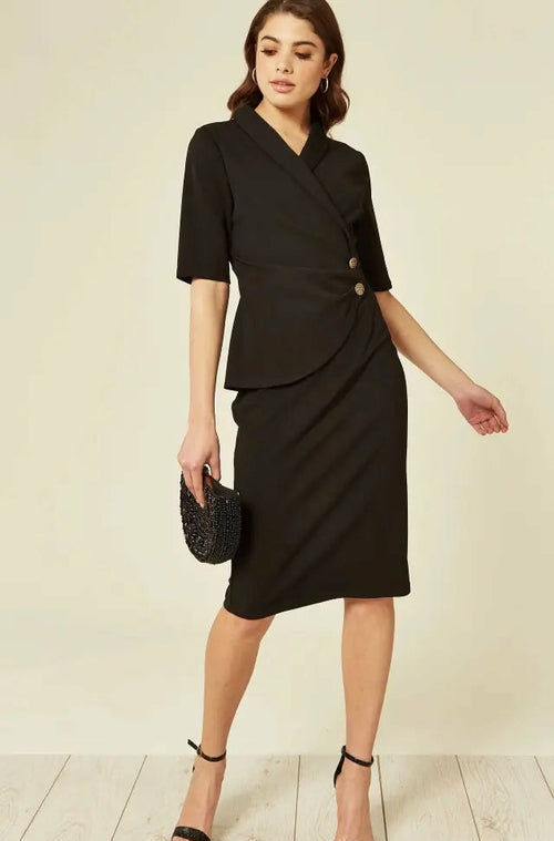 Woman wearing a black dress with a plain background