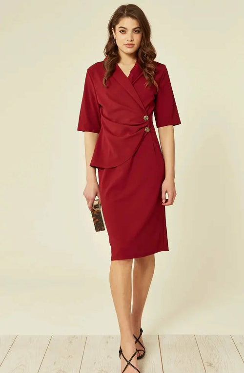 Woman wearing a red dress with a beige background