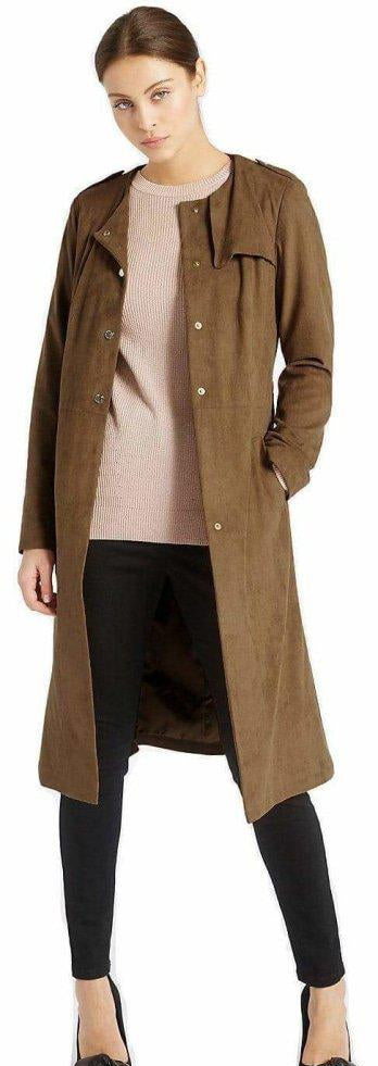 Woman wearing a brown trench coat over a beige top and black pants.