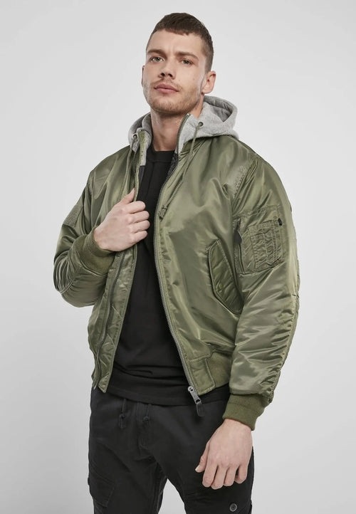 Man wearing a green bomber jacket with a gray hoodie on a white background