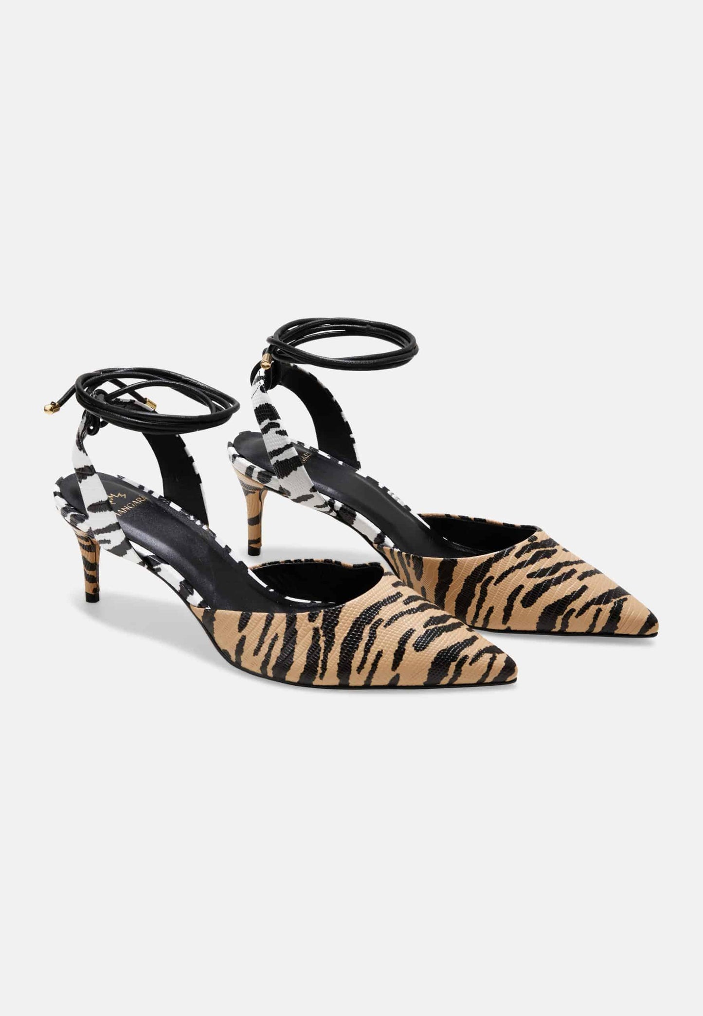 Pair of tiger stripe patterned shoes on a white background