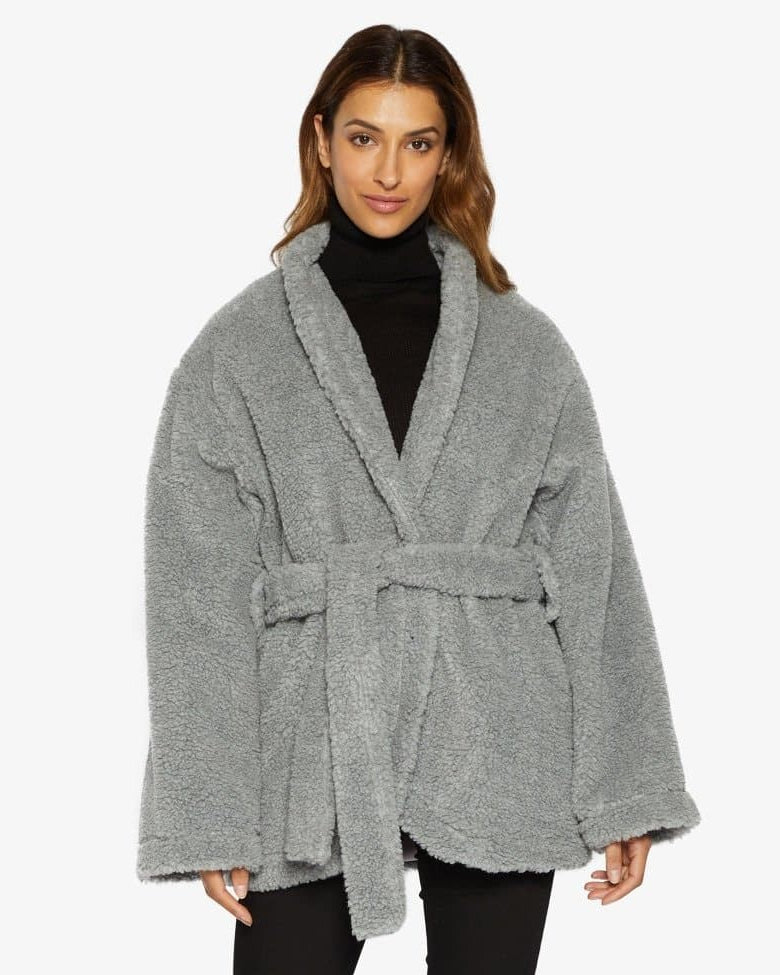 Woman wearing a gray robe with a white background