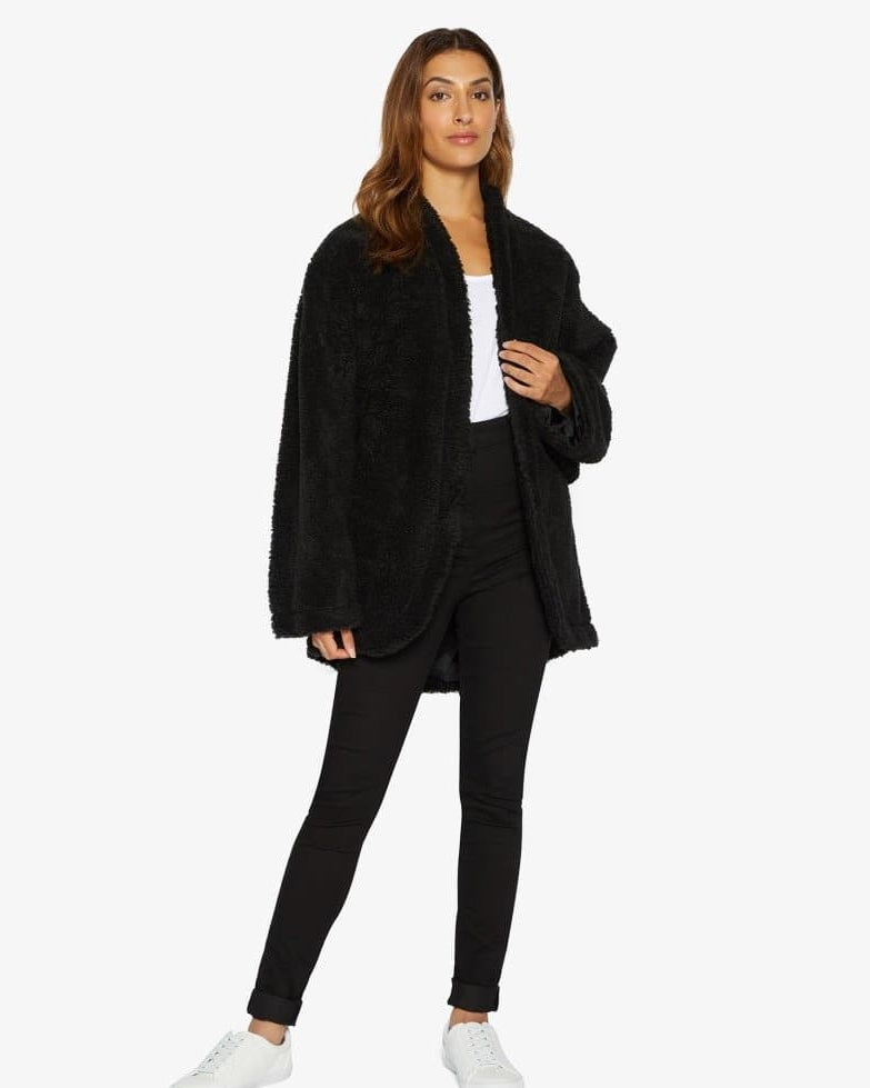 Woman wearing a black outfit with a white background