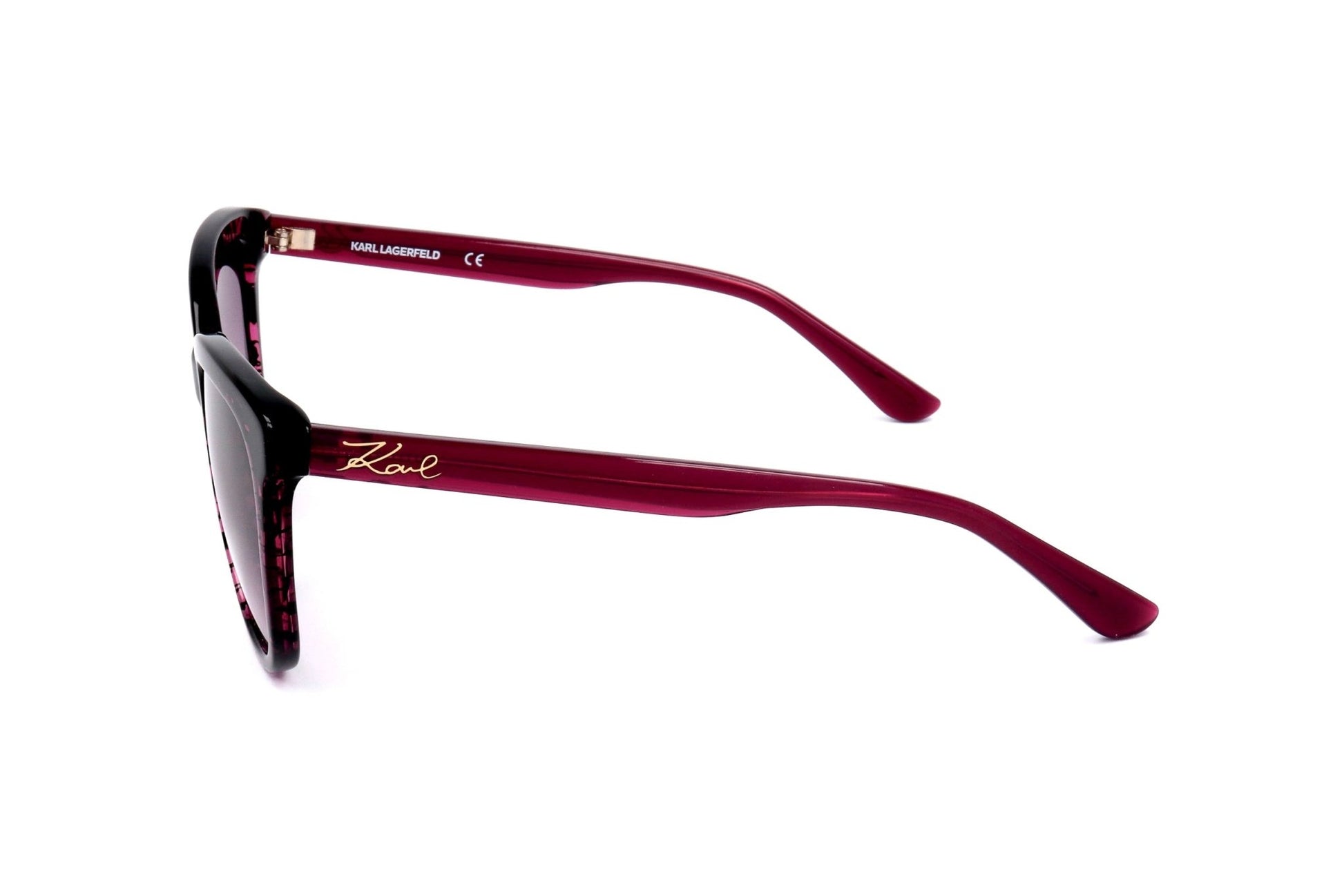 Sunglasses with red frame and 'Karl Lagerfeld' branding on a white background