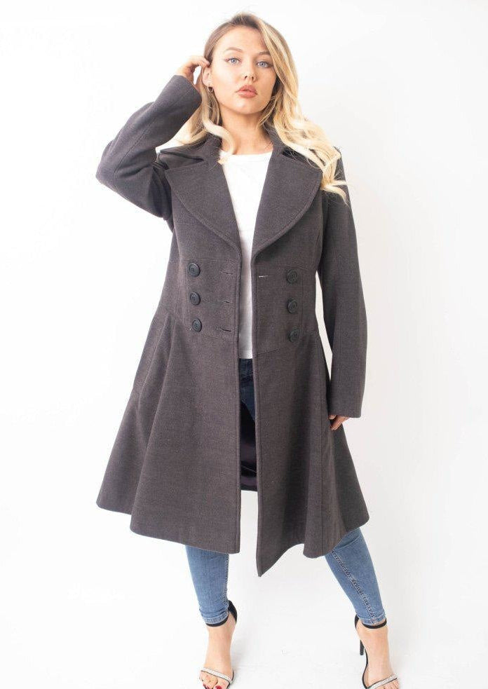 Woman wearing a gray coat on a white background