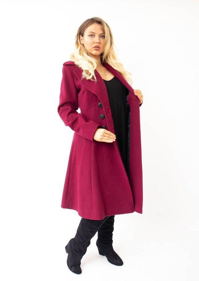 Woman wearing a burgundy coat on a white background