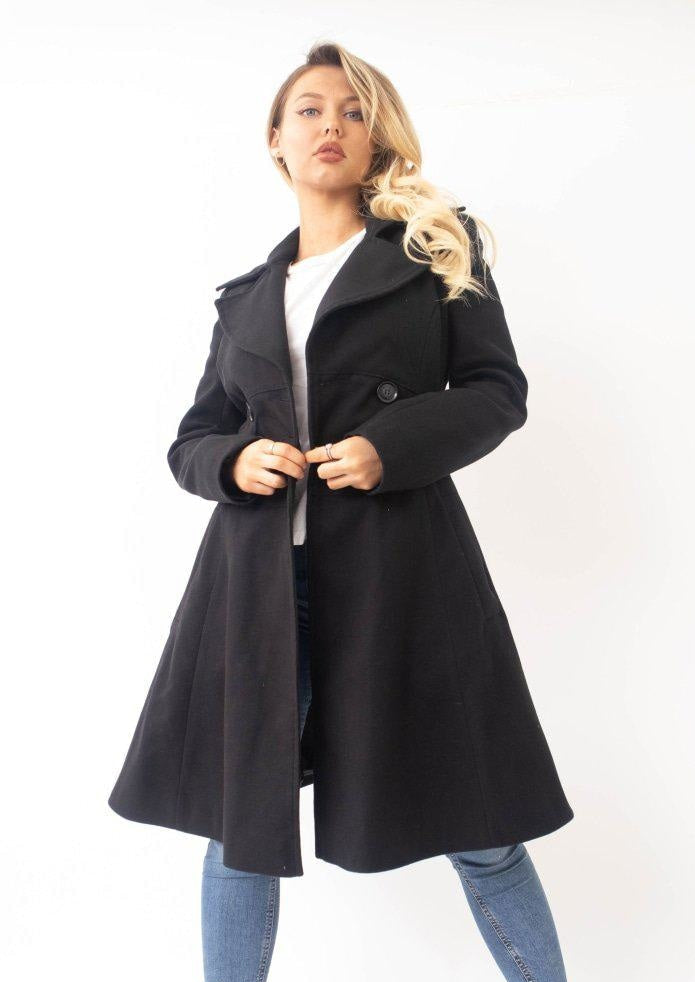 Woman wearing a black coat on a white background