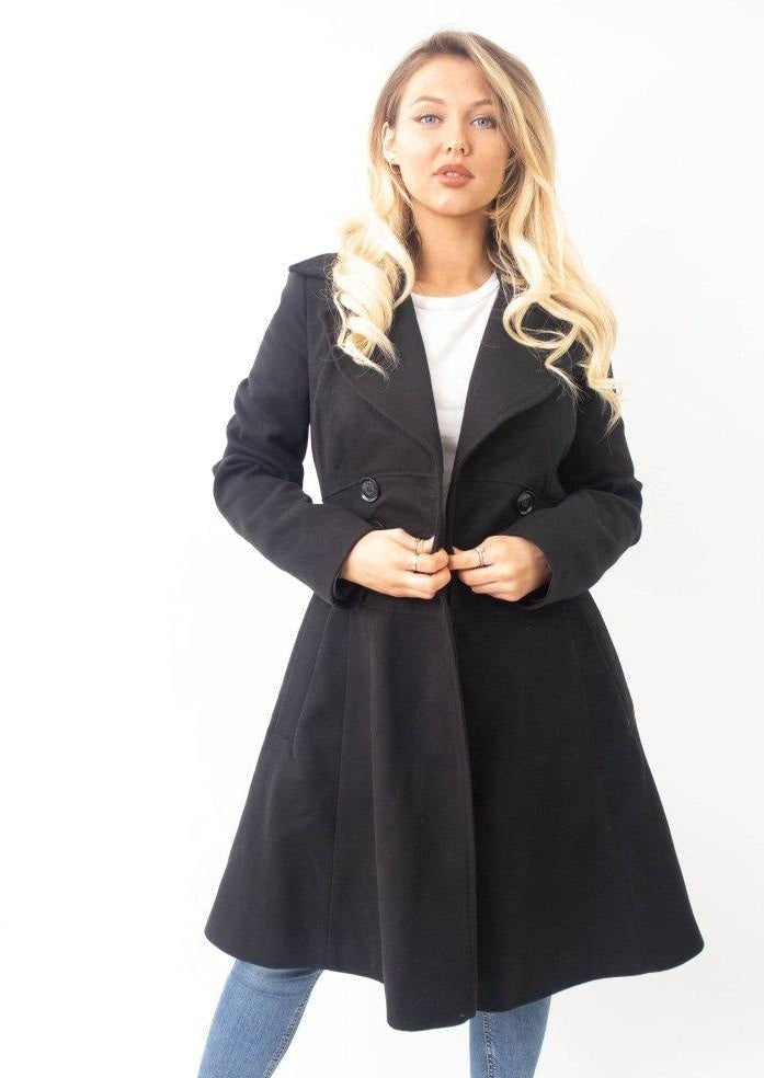 Woman wearing a black coat on a white background