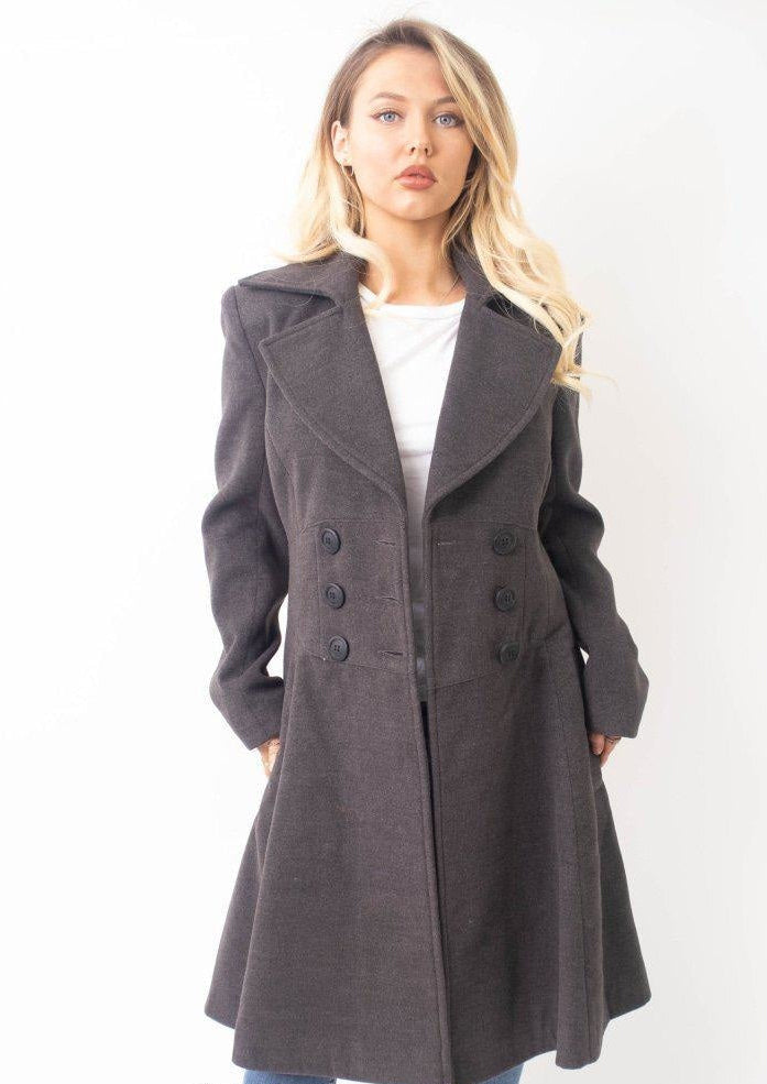 Woman wearing a gray coat on a white background