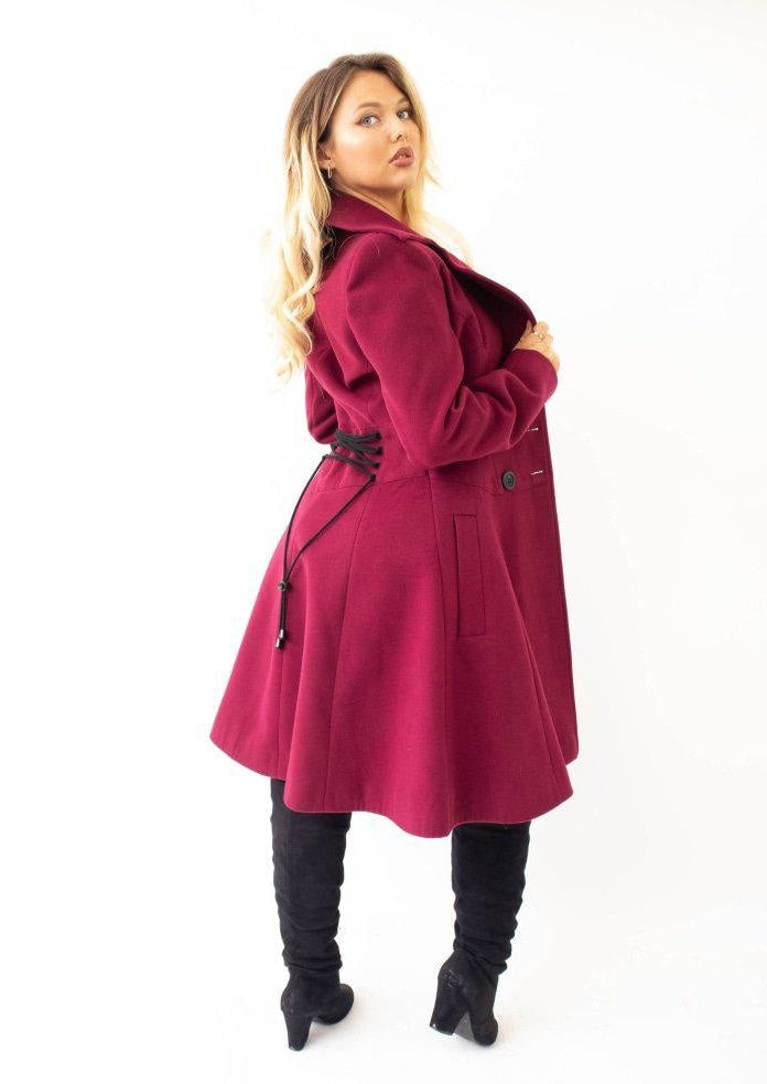 Woman wearing a red coat on a white background