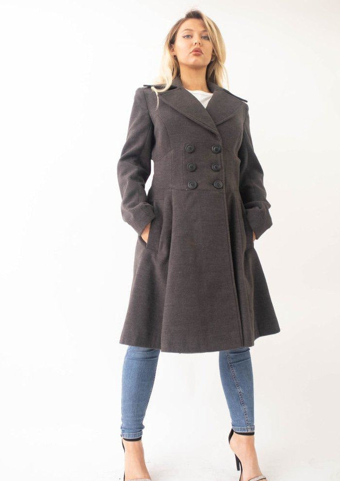 Woman wearing a gray coat with a white background