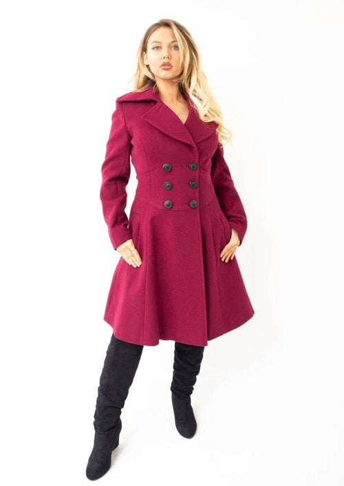 Woman wearing a burgundy coat on a white background