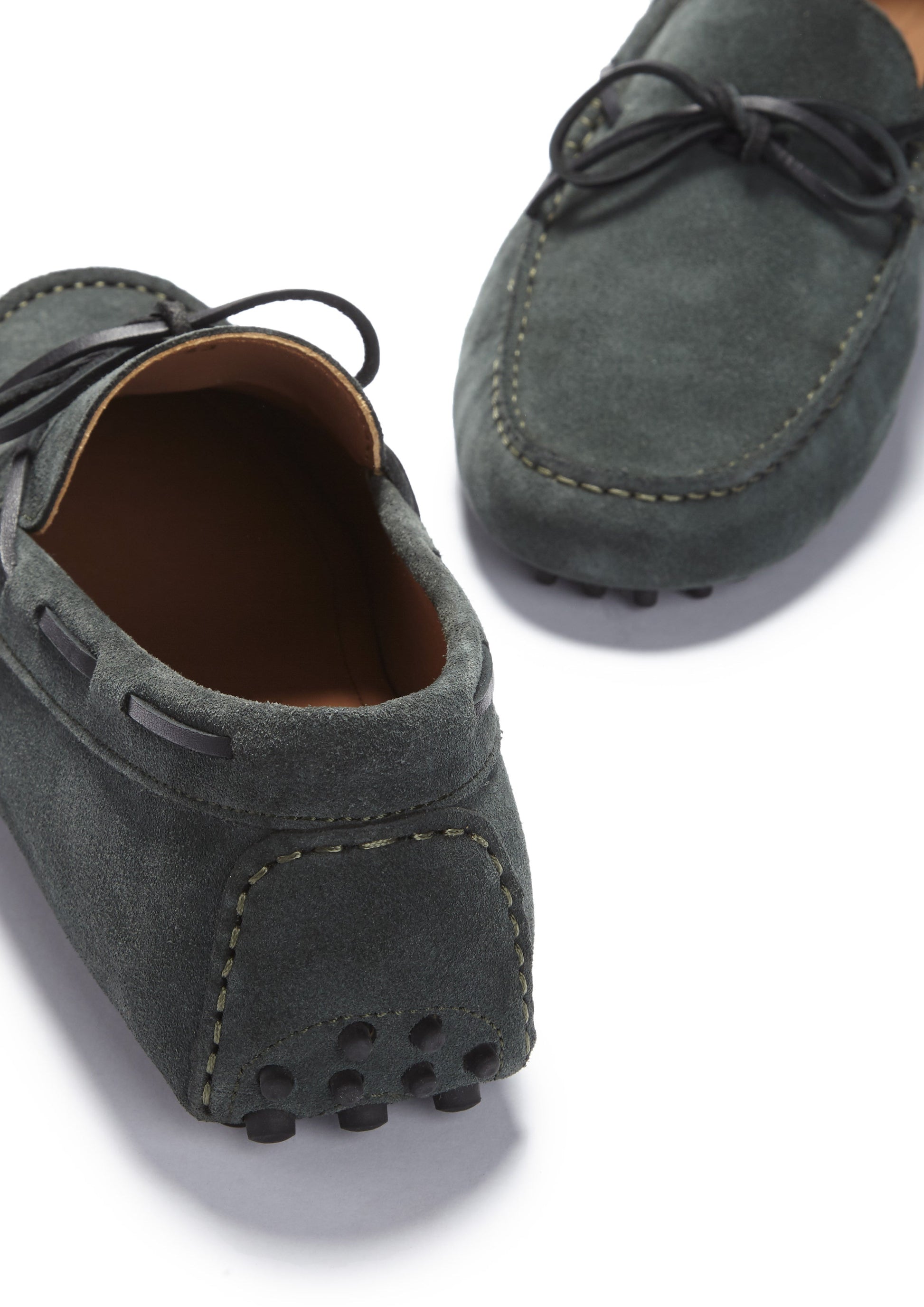 Gray suede loafers on a white background