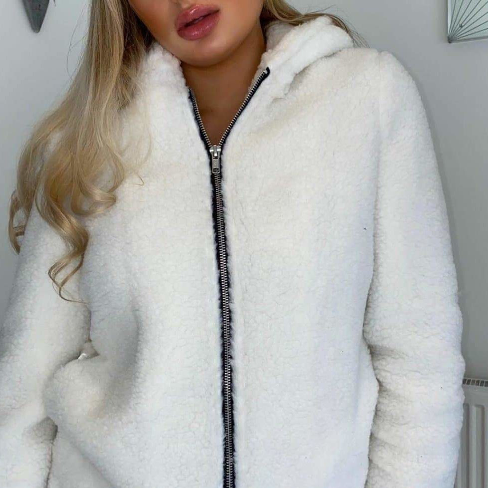 White fluffy jacket with a zipper worn by a person